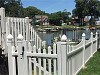 <b>4 foot high white contemporary spaced pointed picket vinyl fence with scalloped layout and french gothic post caps</b>